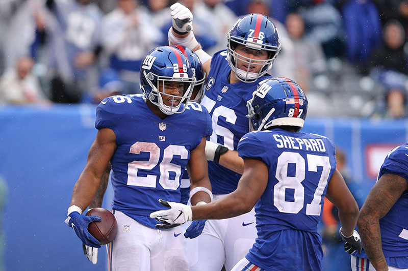 Sep 9, 2018; East Rutherford, NJ, USA; New York Giants running back Saquon Barkley (26) celebrates his touchdown against the Jacksonville Jaguars with offensive tackle Nate Solder (76) and wide receiver Sterling Shepard (87) during the fourth quarter at MetLife Stadium. The touchdown was the first of his NFL career. Mandatory Credit: Brad Penner-USA TODAY Sports